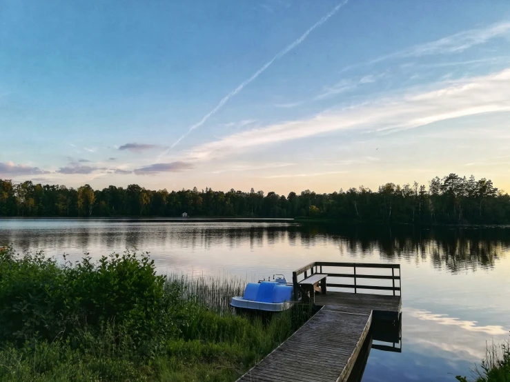 a wooden dock sitting next to a large lake