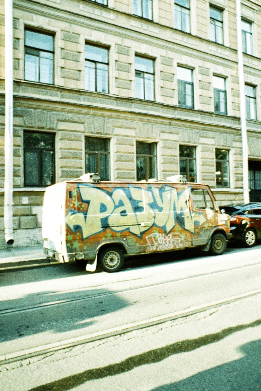 an van is parked on the side of the road