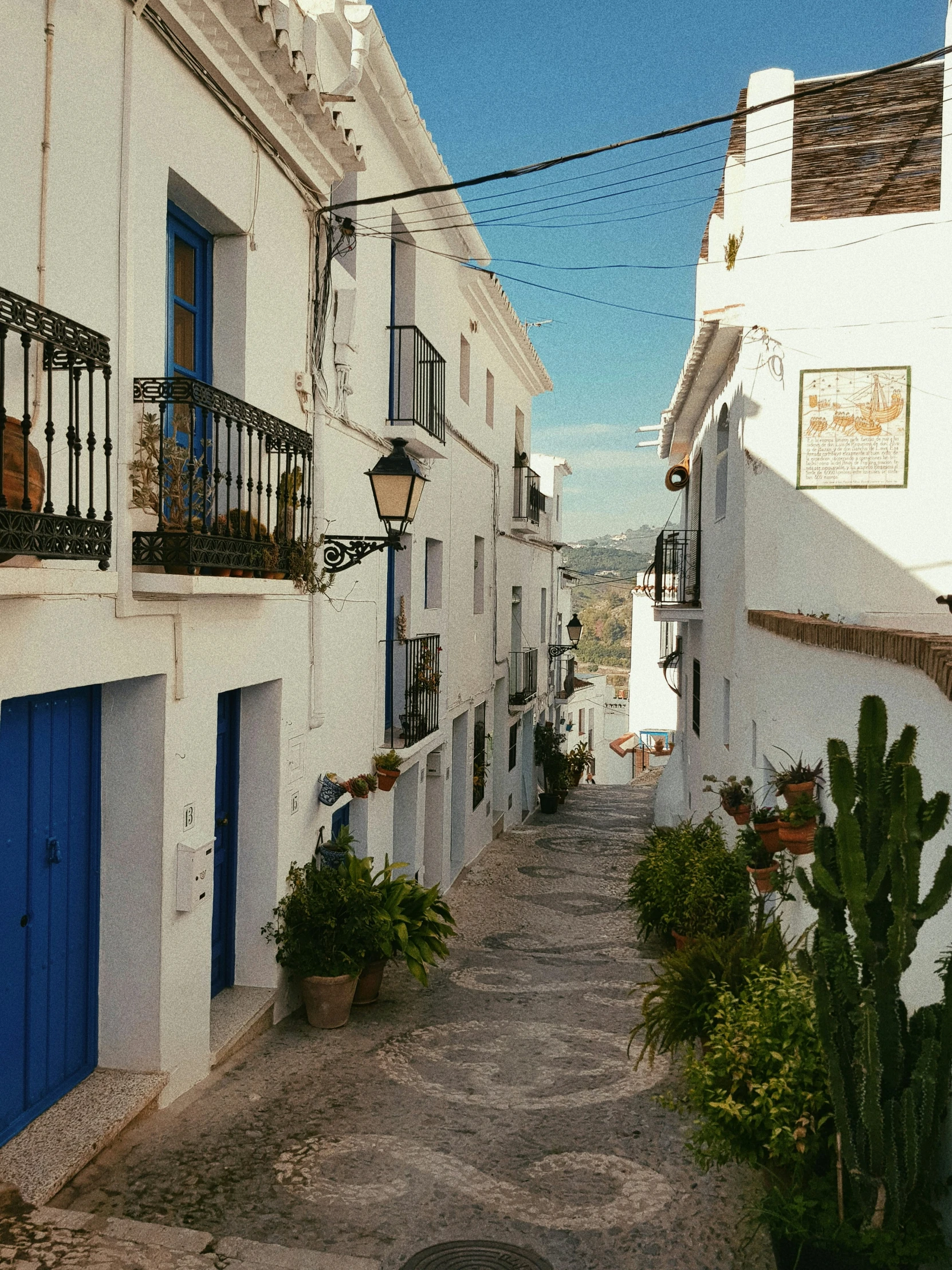 the outside of two buildings with several blue doors