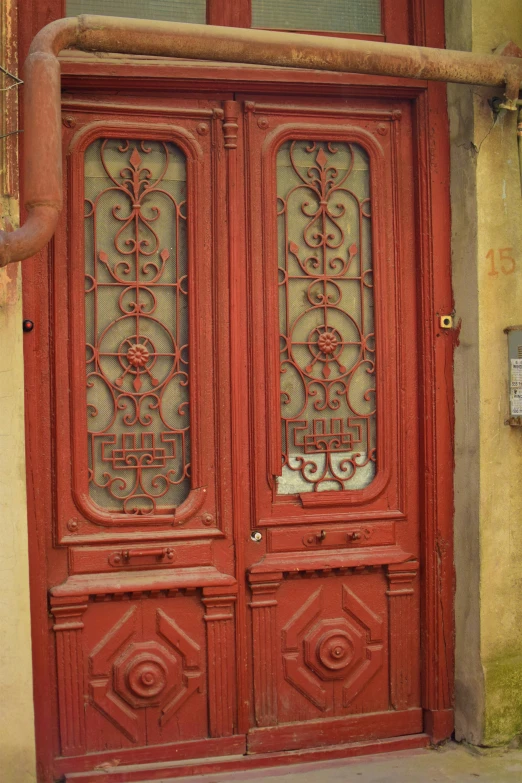 a large red door that has ornate designs on it