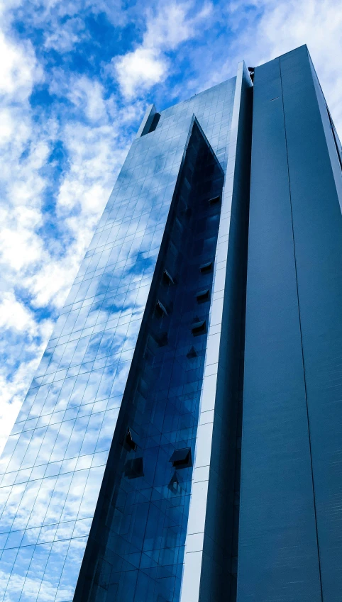 the corner of a tall building with many windows