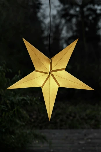 a lantern shaped like a star lit up