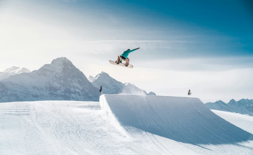 a man that is jumping in the air on a snowboard