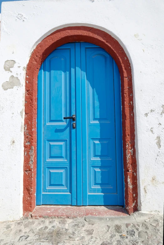 there is a blue door in front of a white building