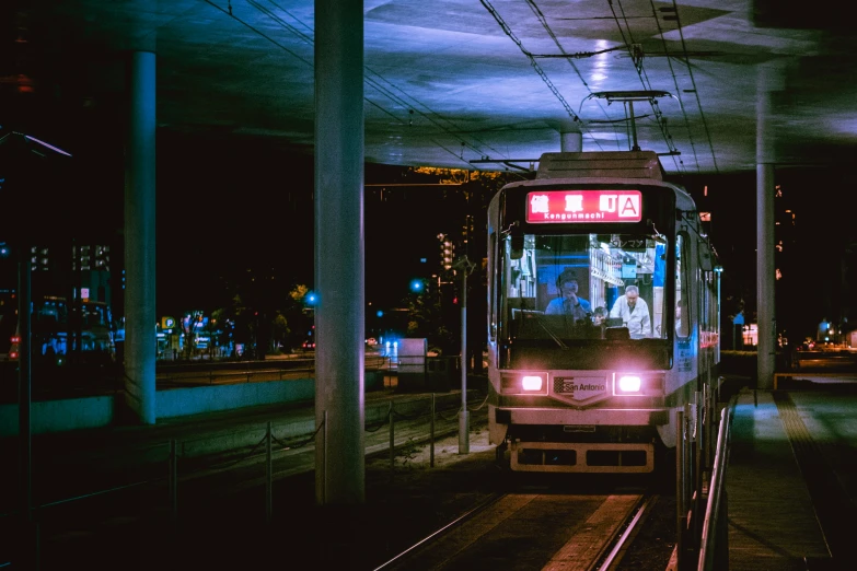 an urban train pulls up to the station