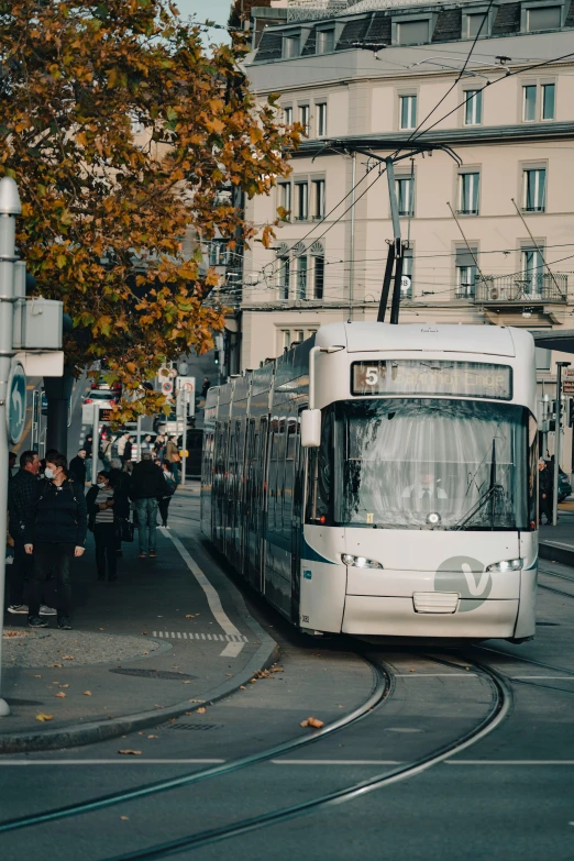 a white trolley is driving down the street