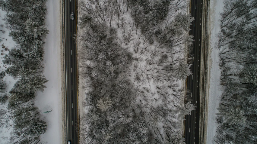 an aerial view of an intersection and roadway in the snow