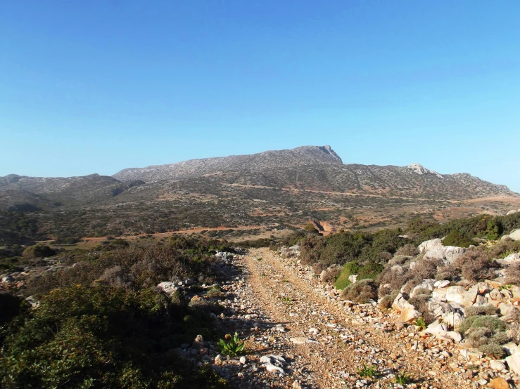 a mountain top with a rocky road winding into the distance