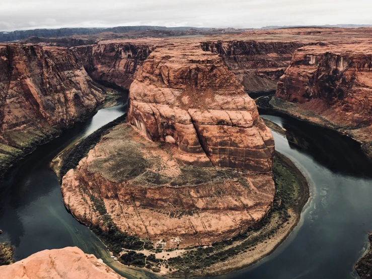 a river surrounded by mountains near a cliff