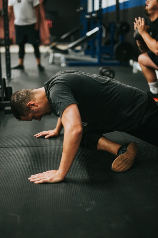 a man performing a squat on a mat