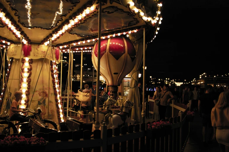 a merry go round with lights in the middle and others in the background