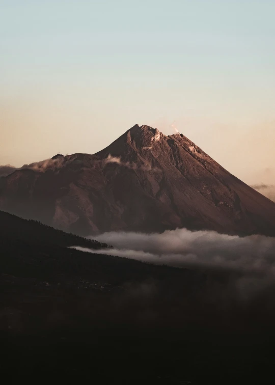 the mountains have a lot of clouds on them