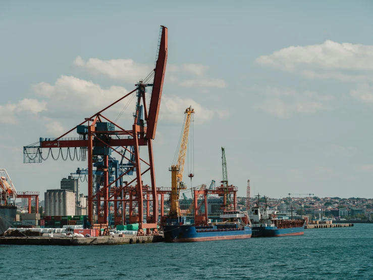 a large crane is near a small boat