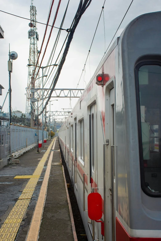 the train is traveling down the tracks through the city