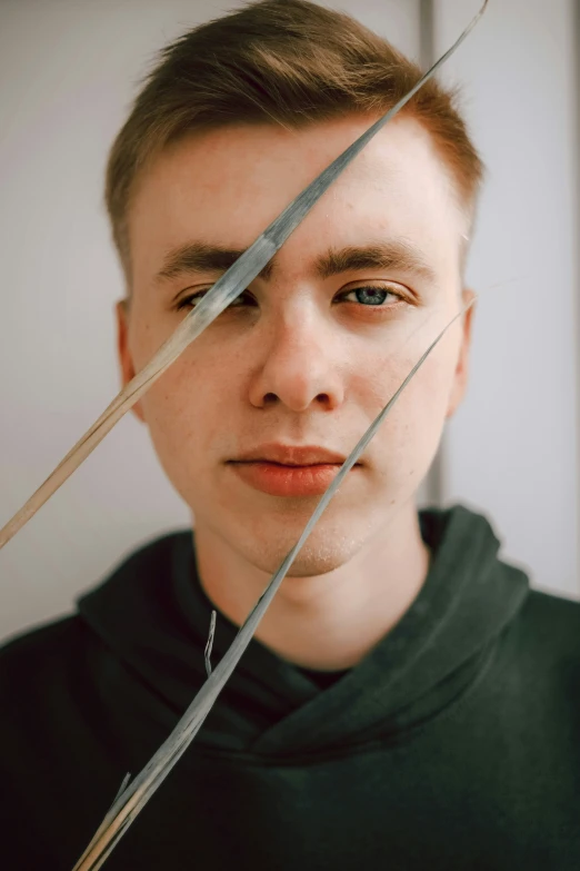 a young man holding two swords over his head