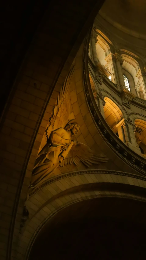 the dome of a building with statues of people on it