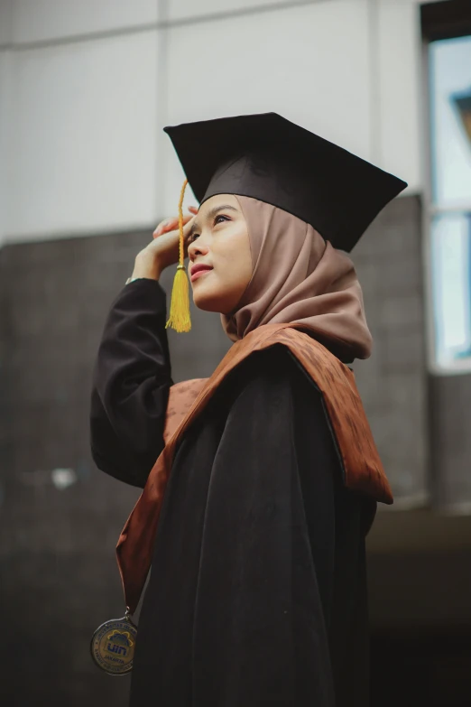 a woman in a graduation cap is walking