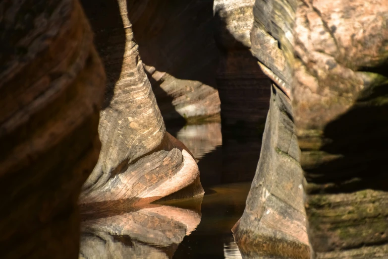 some water is flowing from the rocks in the river