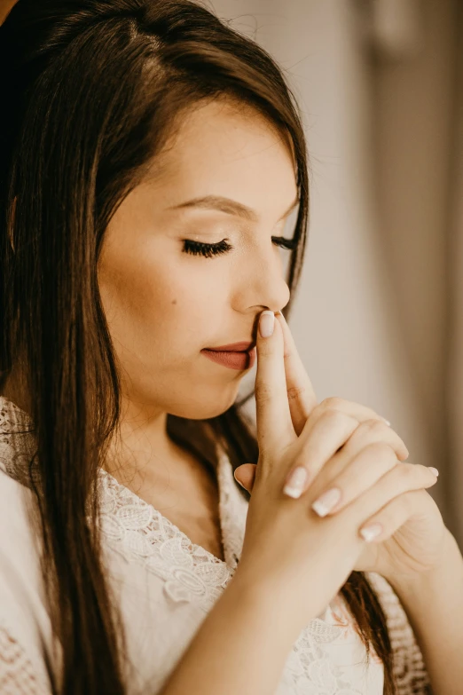 young woman looking down at her finger in an awkward pose