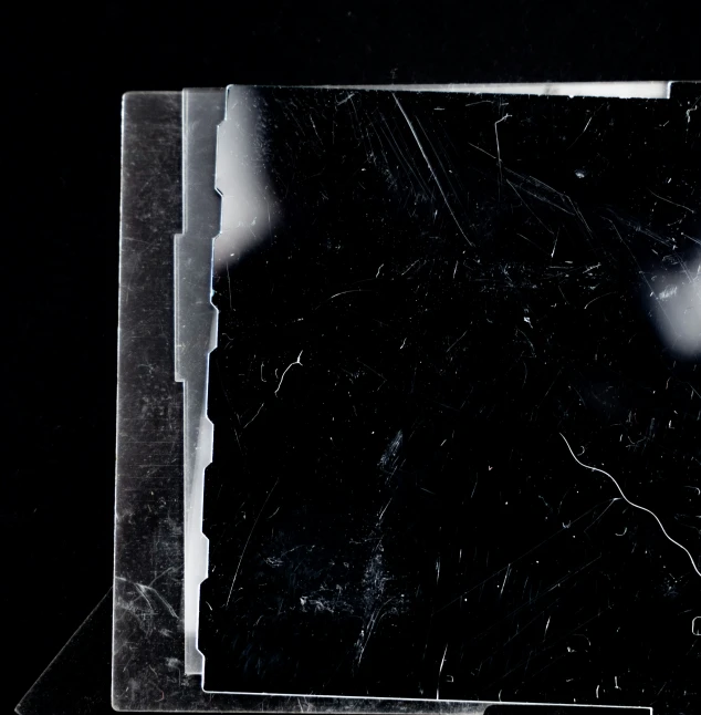 an empty black plastic plate sitting on top of a table