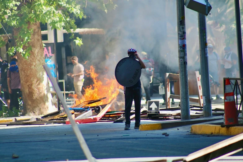 a person in full black gear and hat with fire