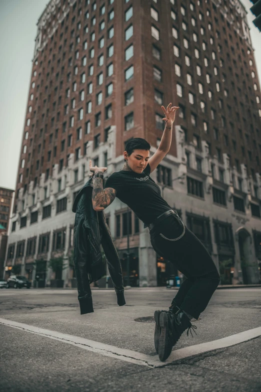 a woman doing a skateboard trick on a city street