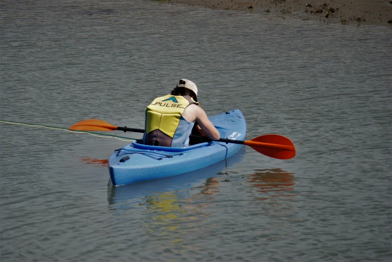 two people in kayaks with paddles are on the water