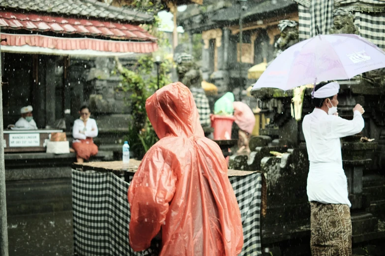 people in the rain with umbrellas over their heads