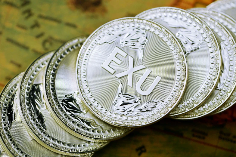 stack of one euro coin next to a map