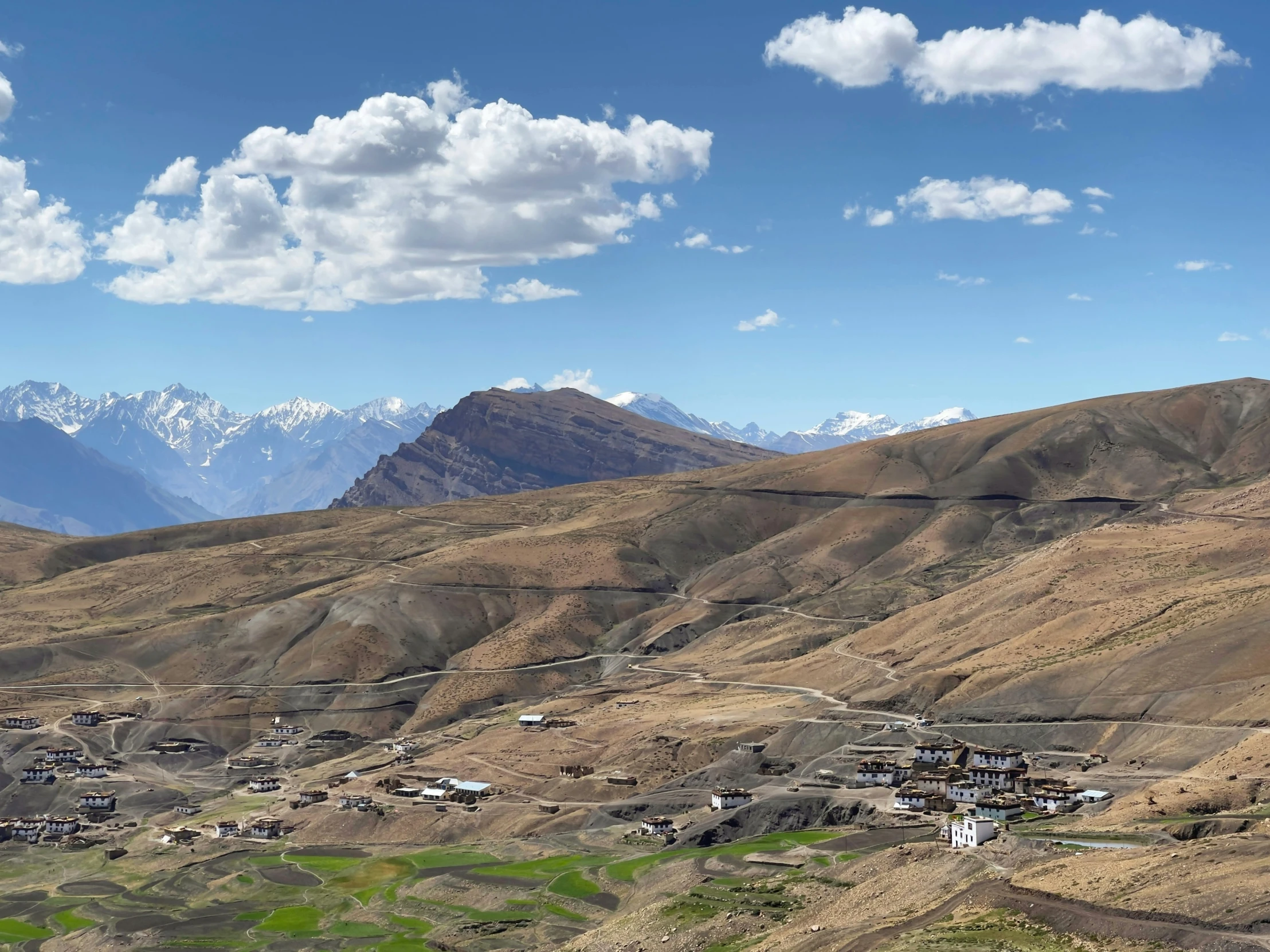 a picture of a group of houses in the mountains