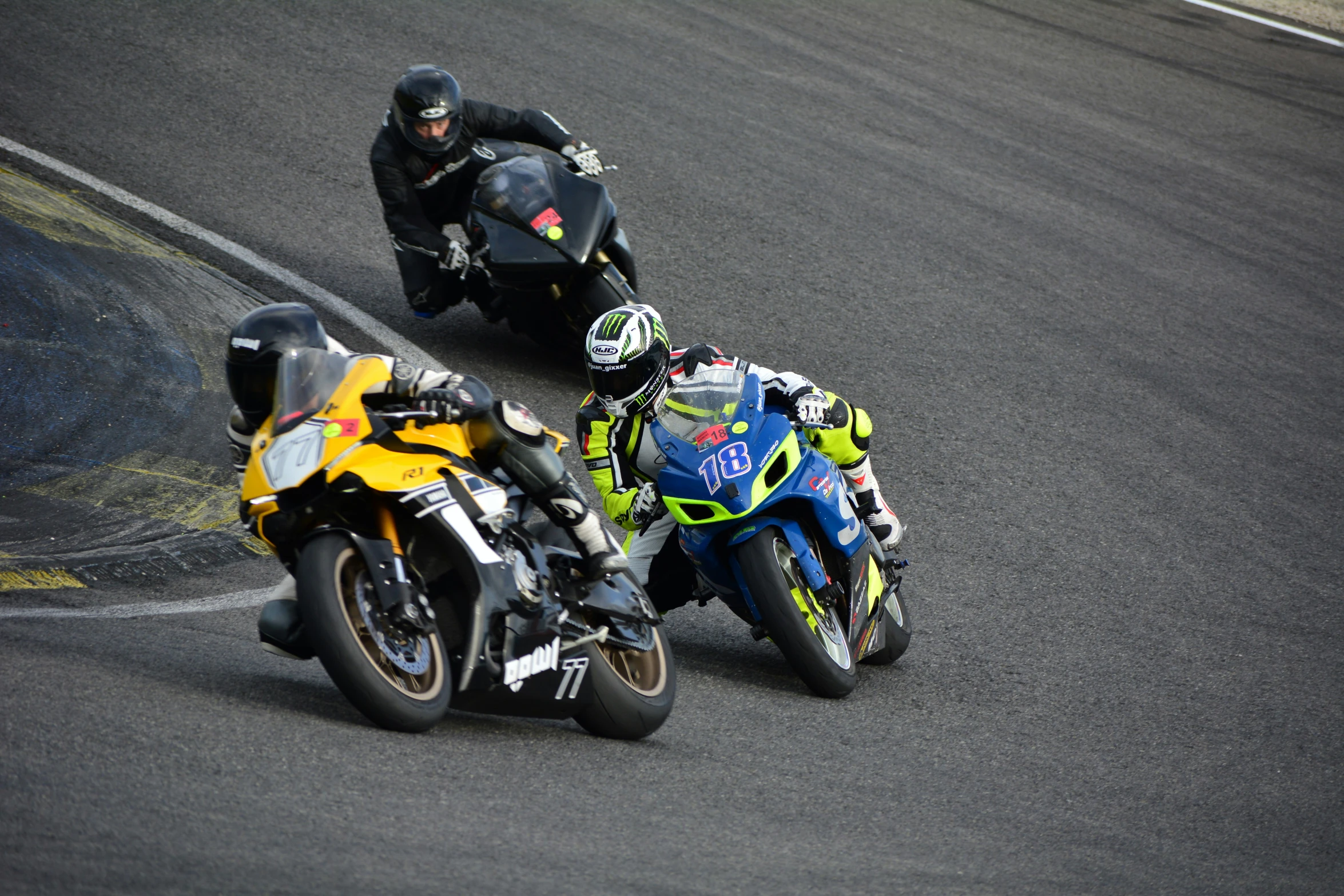 two people on motorcycles race around a curve