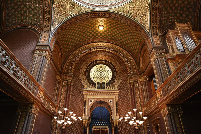 an ornate gold ceiling inside a church with chandeliers