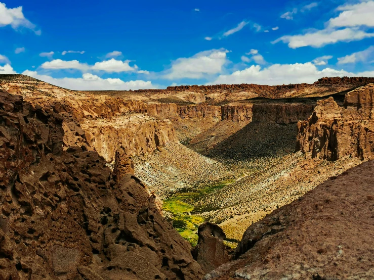 a canyon with brown cliffs in the background