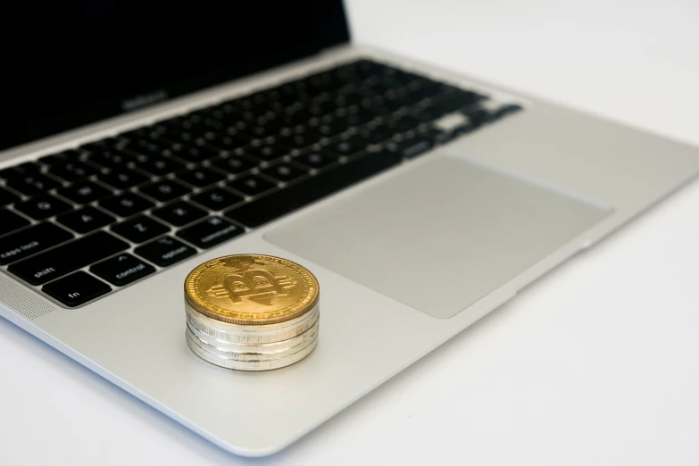 the pound coins are sitting next to a laptop