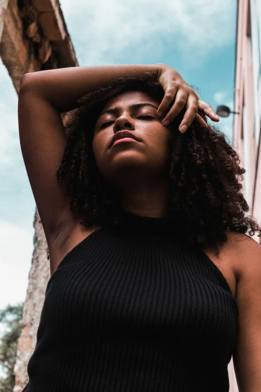 a black woman standing on a city street