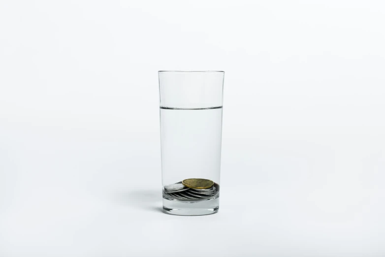 a glass with some coins inside of it