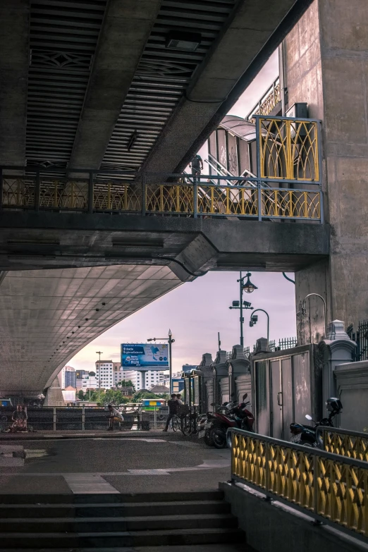 a street filled with lots of traffic next to a tall bridge