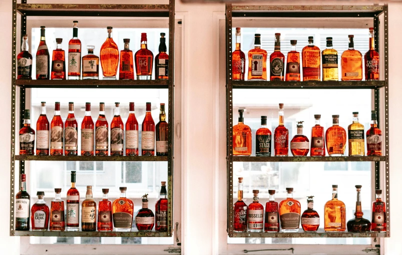 several shelves filled with lots of different types of liquor