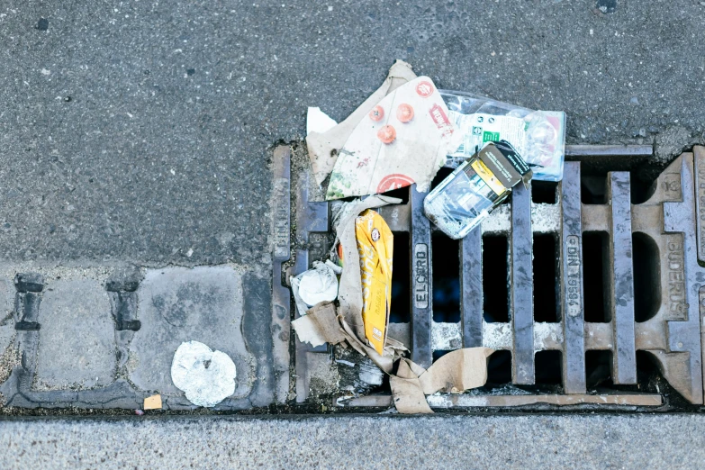 garbage, bottles and other household items on a grate