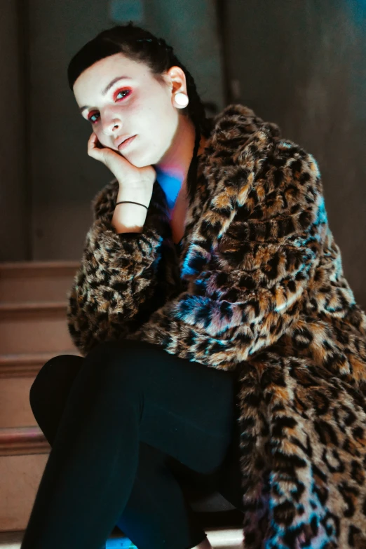 a woman sits on some steps while looking serious