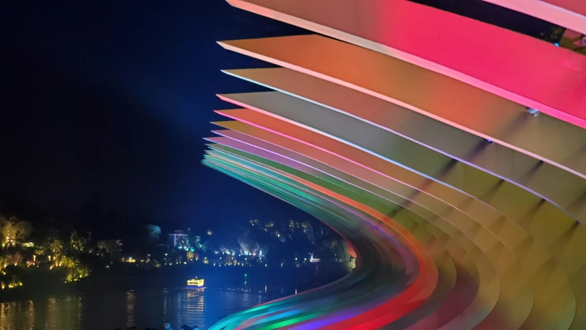 a curved walkway with a lit up area above