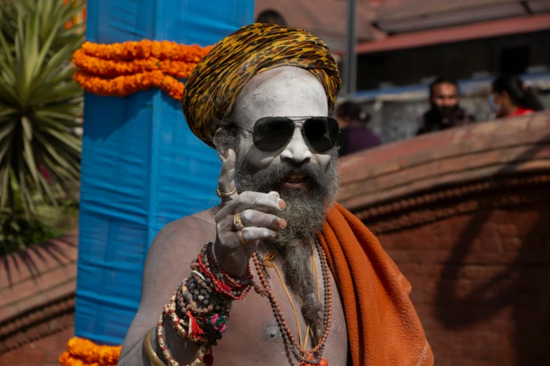 a man in shades with a beard and beard ring