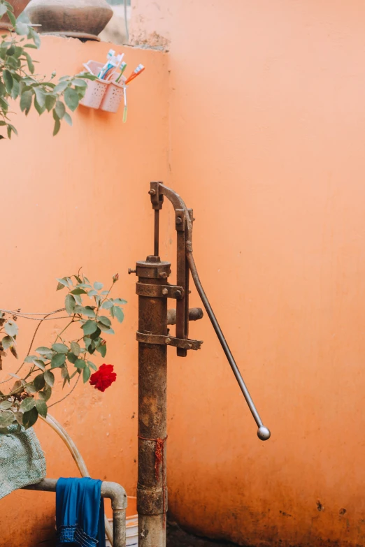 a spigot attached to a pipe with a water hose