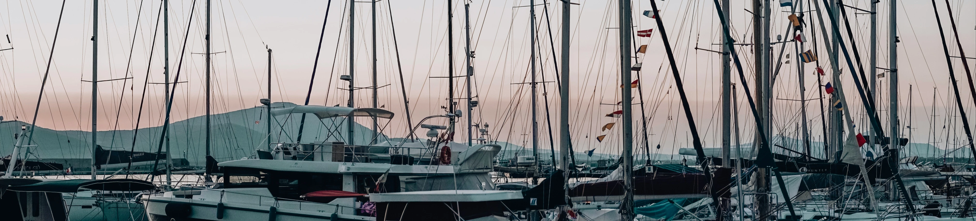 several boats are docked in the water with lots of junk