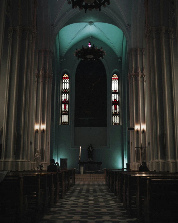 inside of an old building with several stained glass windows