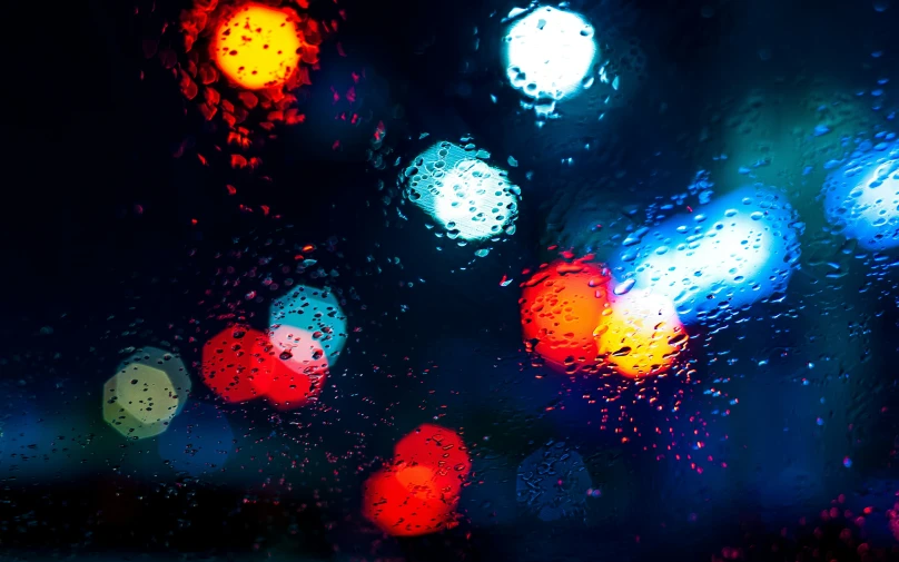 a traffic light seen through a rain covered window