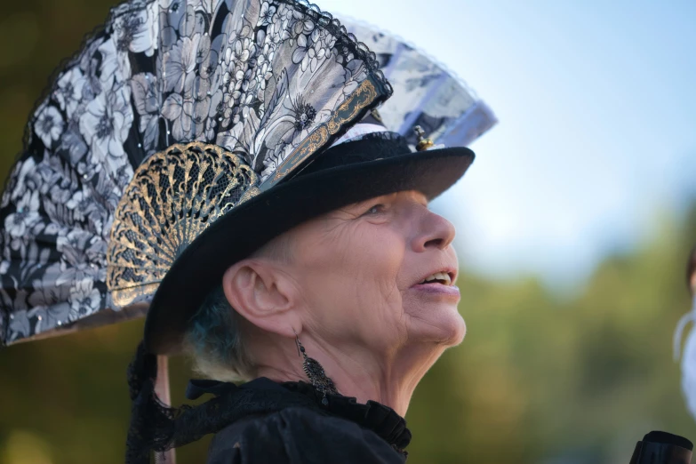 an old woman in a black dress and hat