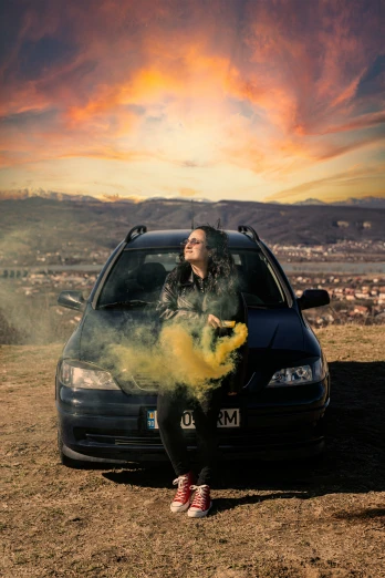 man blowing smoke into his car while the sun sets