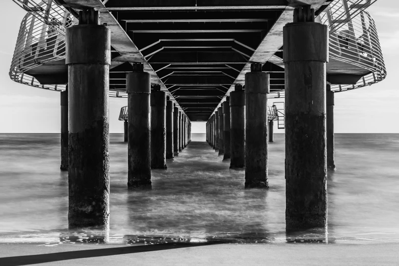 a walkway leading to a pier with water on both sides