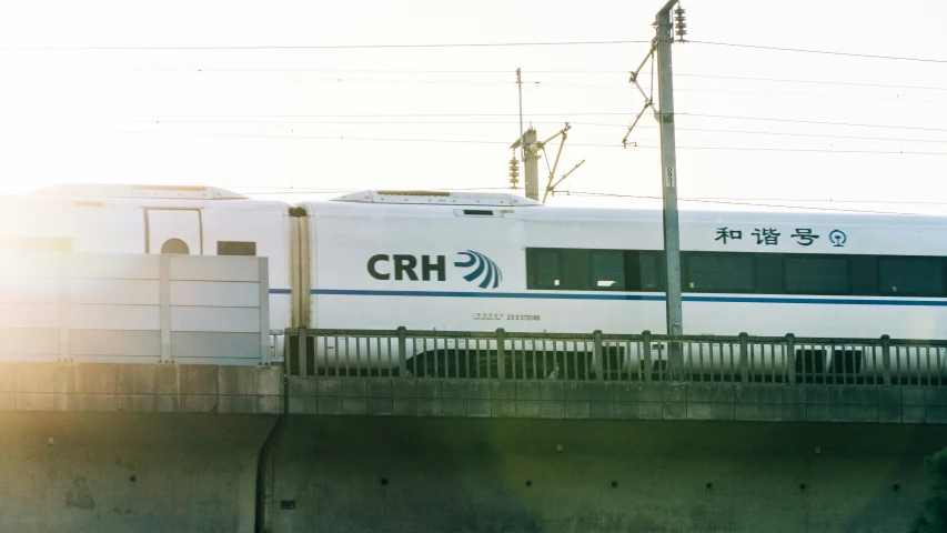 an oriental passenger train riding along the railroad tracks